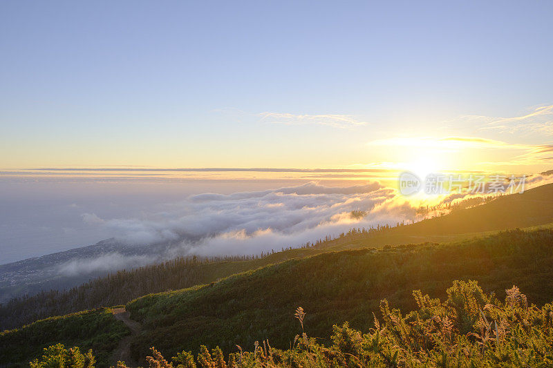 Clouds over the mountains near Rabaçal on Madeira island during sunset